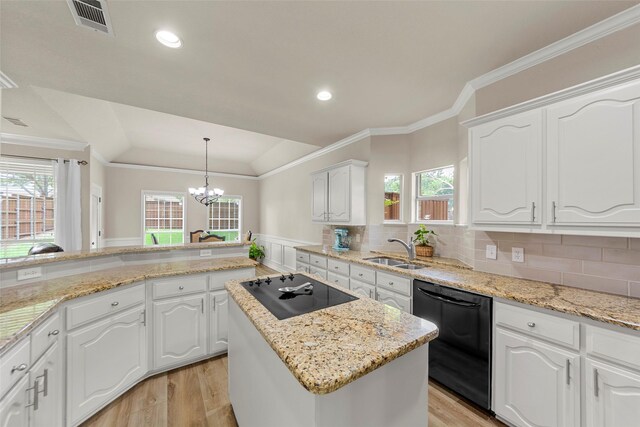 1 Parkside Cir, Allen, TX 75013 - kitchen with black appliances, a sink, light wood-type flooring, a chandelier, and wainscoting
