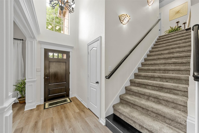 1 Parkside Cir, Allen, TX 75013 - foyer entrance with stairs, light wood-style flooring, a towering ceiling, and ornate columns