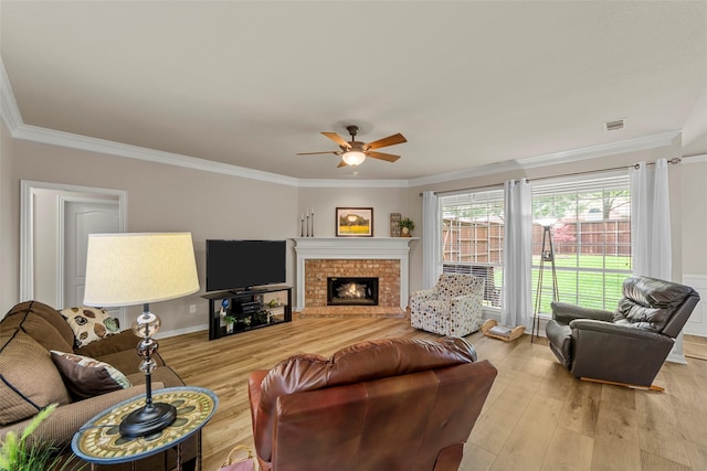 1 Parkside Cir, Allen, TX 75013 - living area with a ceiling fan, ornamental molding, light wood-style floors, and a brick fireplace