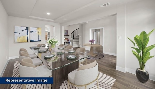 14897 Grand Highlands, Frisco, TX 75035 - dining space featuring stairway, baseboards, wood finished floors, a tray ceiling, and recessed lighting
