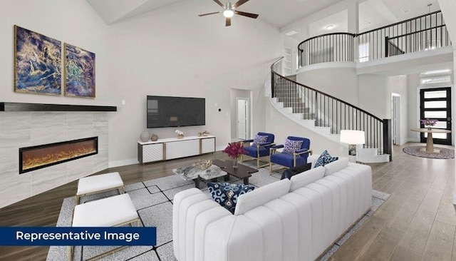14897 Grand Highlands, Frisco, TX 75035 - living area with a high ceiling, stairway, a ceiling fan, a fireplace, and wood finished floors