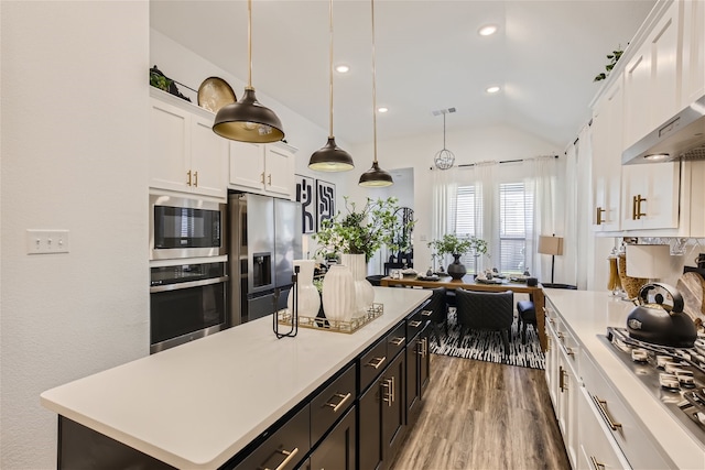 3906 Chesapeake Ln, Crandall, TX 75114 - kitchen featuring stainless steel appliances, white cabinetry, wall chimney exhaust hood, light countertops, and vaulted ceiling
