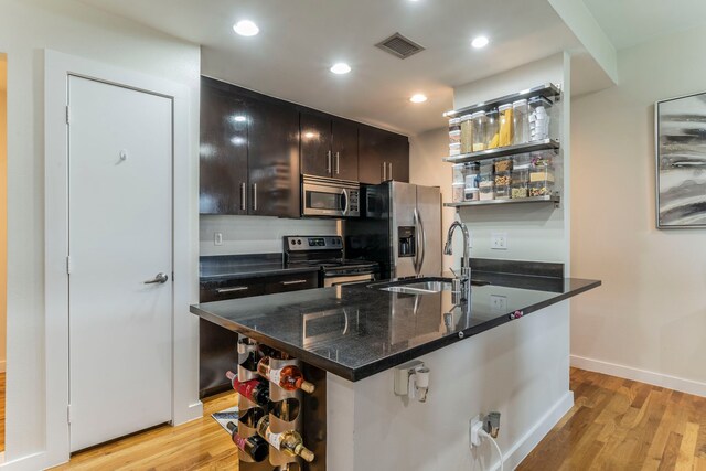5806 Birchbrook Dr Unit 203, Dallas, TX 75206 - kitchen with stainless steel appliances, open shelves, a sink, light wood finished floors, and recessed lighting
