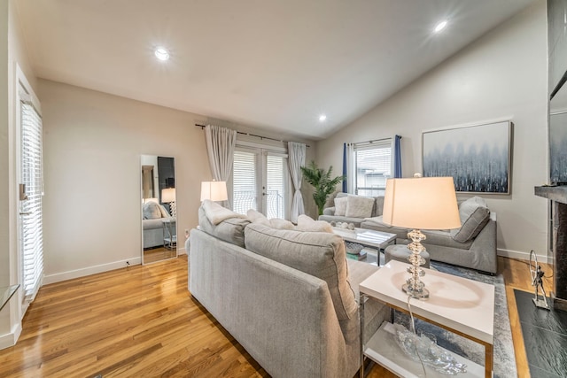 5806 Birchbrook Dr Unit 203, Dallas, TX 75206 - living room featuring light wood finished floors, vaulted ceiling, baseboards, and recessed lighting