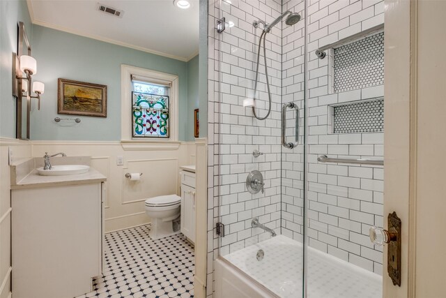 533 Newell Ave, Dallas, TX 75223 - bathroom featuring vanity, ornamental molding, a wainscoted wall, toilet, and shower / bath combination with glass door
