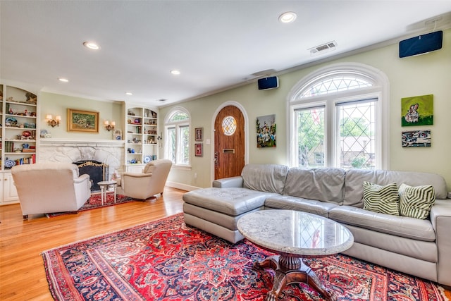 533 Newell Ave, Dallas, TX 75223 - living room featuring wood finished floors, a fireplace, recessed lighting, built in features, and baseboards