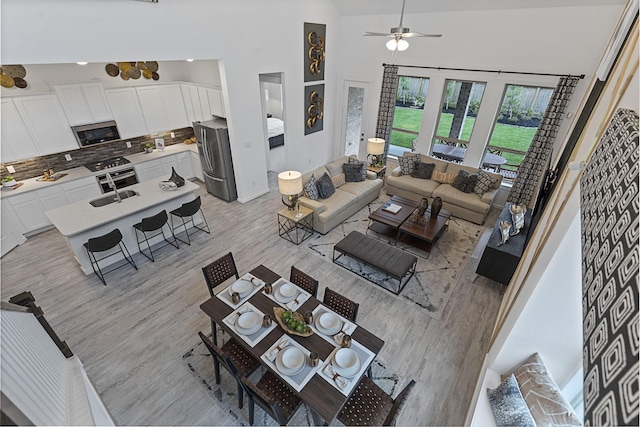 9305 Derry Ln, Aubrey, TX 76227 - living area with ceiling fan, light wood-style floors, and high vaulted ceiling
