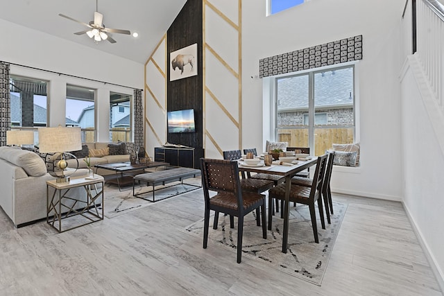 9305 Derry Ln, Aubrey, TX 76227 - dining space featuring a high ceiling, light wood-type flooring, a ceiling fan, and baseboards