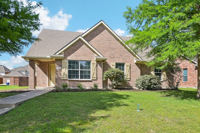 1280 Seymour Dr, Frisco, TX 75034 - view of front of home with a front yard, brick siding, and roof with shingles