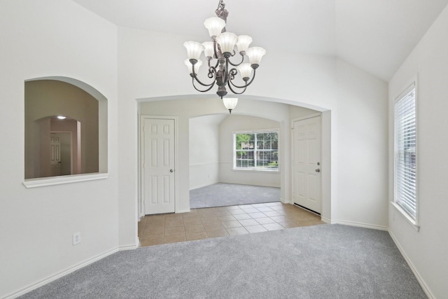 1280 Seymour Dr, Frisco, TX 75034 - unfurnished room with carpet flooring, tile patterned floors, a chandelier, vaulted ceiling, and arched walkways