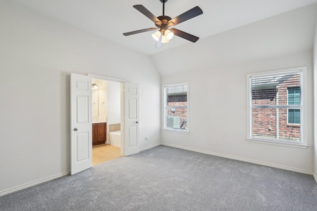 1280 Seymour Dr, Frisco, TX 75034 - unfurnished bedroom featuring light colored carpet, baseboards, lofted ceiling, connected bathroom, and ceiling fan