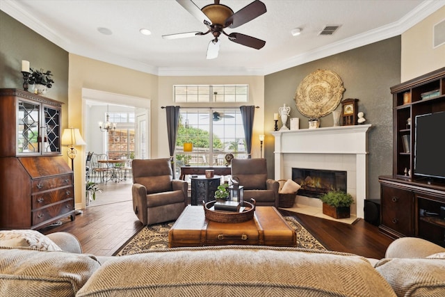 1300 Darbyton Dr, Hewitt, TX 76643 - living area with a ceiling fan, hardwood / wood-style flooring, crown molding, a chandelier, and a tile fireplace