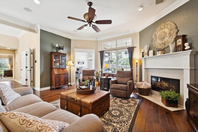 1300 Darbyton Dr, Hewitt, TX 76643 - living room featuring wood-type flooring, a ceiling fan, crown molding, a fireplace, and baseboards