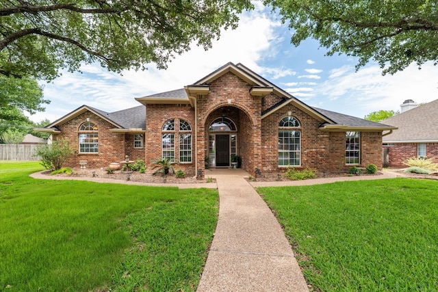 1300 Darbyton Dr, Hewitt, TX 76643 - traditional-style house featuring brick siding, a front yard, and roof with shingles