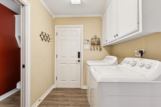 1300 Darbyton Dr, Hewitt, TX 76643 - laundry room featuring cabinet space, washing machine and clothes dryer, wood finished floors, ornamental molding, and baseboards