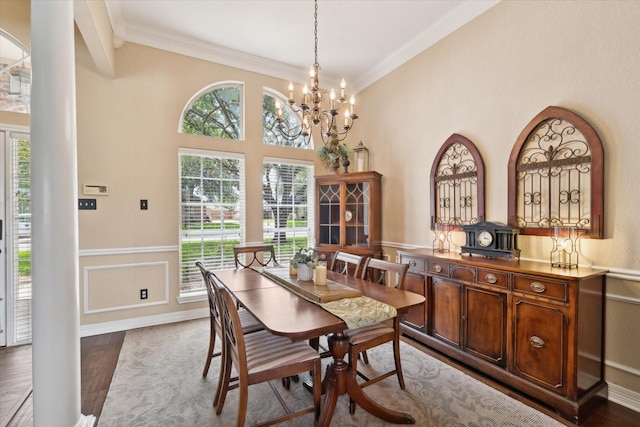 1300 Darbyton Dr, Hewitt, TX 76643 - dining room featuring healthy amount of natural light, ornamental molding, a chandelier, wood finished floors, and a wainscoted wall