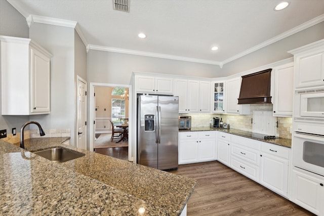1300 Darbyton Dr, Hewitt, TX 76643 - kitchen featuring stainless steel refrigerator with ice dispenser, a sink, oven, custom exhaust hood, and wood finished floors