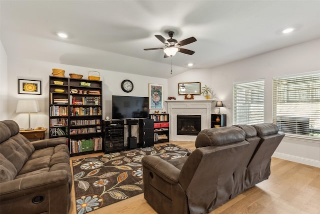 1224 Johnson Dr, Celina, TX 75009 - living room with a ceiling fan, wood finished floors, a glass covered fireplace, recessed lighting, and baseboards