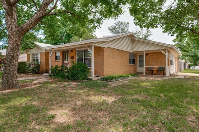 2002 Winthrop St, Irving, TX 75061 - ranch-style house with brick siding, a front lawn, and a porch