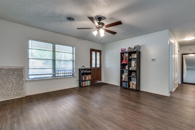 2002 Winthrop St, Irving, TX 75061 - living area with wood finished floors, ceiling fan, a textured ceiling, and baseboards