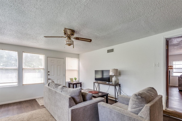 2002 Winthrop St, Irving, TX 75061 - living room with ceiling fan, a textured ceiling, and dark wood finished floors