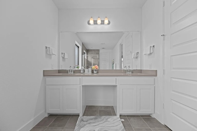 516 Secretariat Dr, Rowlett, TX 75088 - full bath with double vanity, a stall shower, tile patterned floors, and baseboards