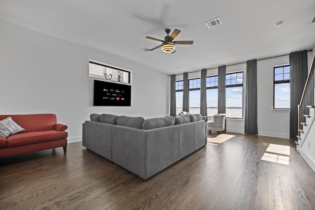 516 Secretariat Dr, Rowlett, TX 75088 - living room with stairs, a ceiling fan, dark wood-style flooring, and baseboards
