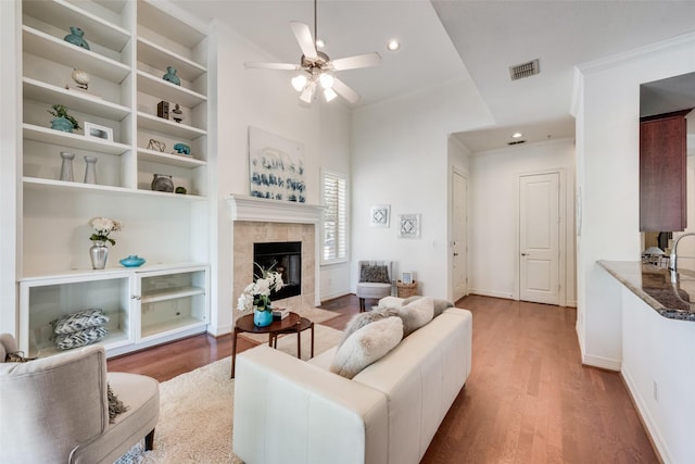 1400 Clarinet Ln, Plano, TX 75074 - living area with wood finished floors, built in shelves, ceiling fan, a fireplace, and baseboards