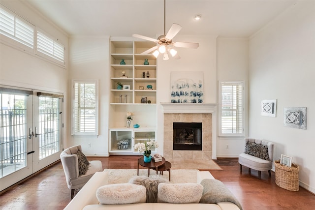 1400 Clarinet Ln, Plano, TX 75074 - living room featuring healthy amount of natural light, wood finished floors, a fireplace, baseboards, and a high ceiling
