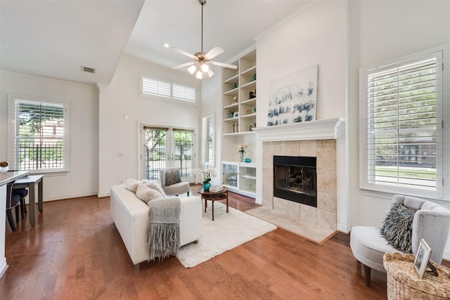 1400 Clarinet Ln, Plano, TX 75074 - living room featuring built in shelves, ceiling fan, wood finished floors, baseboards, and ornamental molding