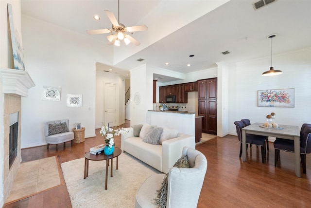 1400 Clarinet Ln, Plano, TX 75074 - living area featuring light wood-style floors, a ceiling fan, a tile fireplace, recessed lighting, and baseboards