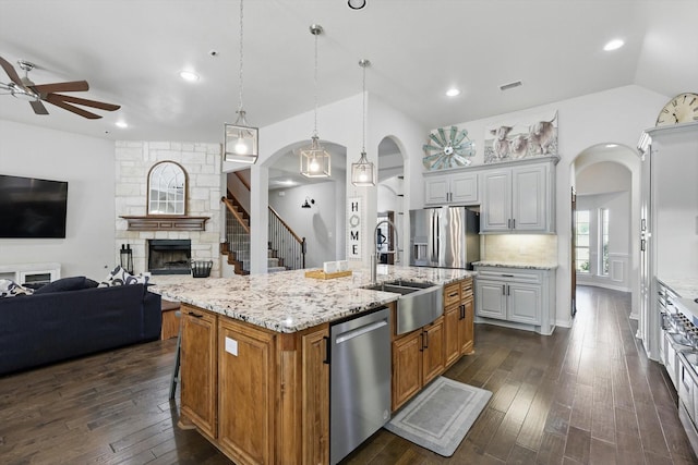 163 Las Colinas Trl, Cross Roads, TX 76227 - kitchen with stainless steel appliances, open floor plan, a ceiling fan, arched walkways, and lofted ceiling