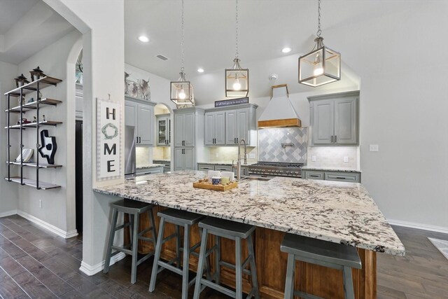 163 Las Colinas Trl, Cross Roads, TX 76227 - kitchen with premium range hood, a sink, gray cabinetry, arched walkways, and backsplash