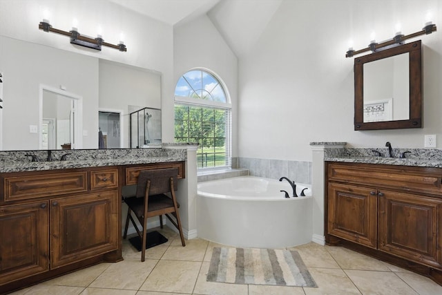 163 Las Colinas Trl, Cross Roads, TX 76227 - full bath with vaulted ceiling, a shower stall, a garden tub, two vanities, and tile patterned floors