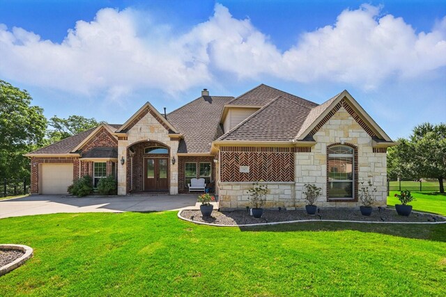 163 Las Colinas Trl, Cross Roads, TX 76227 - french country inspired facade with stone siding, a shingled roof, a garage, and concrete driveway