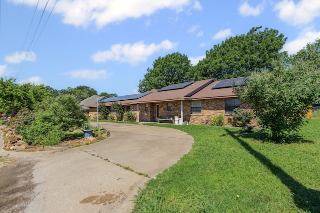 100 Yorkshire Dr, Princeton, TX 75407 - single story home featuring a front lawn, roof mounted solar panels, and brick siding