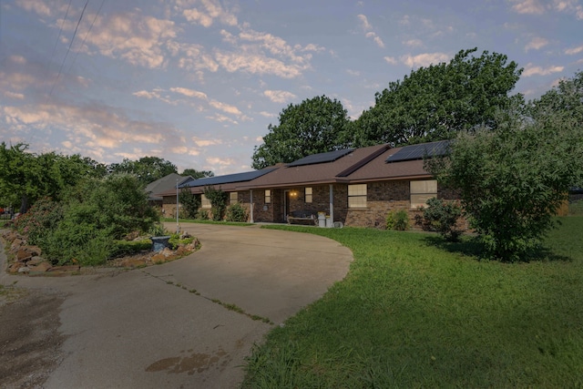 100 Yorkshire Dr, Princeton, TX 75407 - view of front of property featuring a front yard, roof mounted solar panels, and brick siding