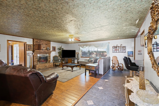 100 Yorkshire Dr, Princeton, TX 75407 - living room with ceiling fan, a brick fireplace, crown molding, and tile patterned flooring
