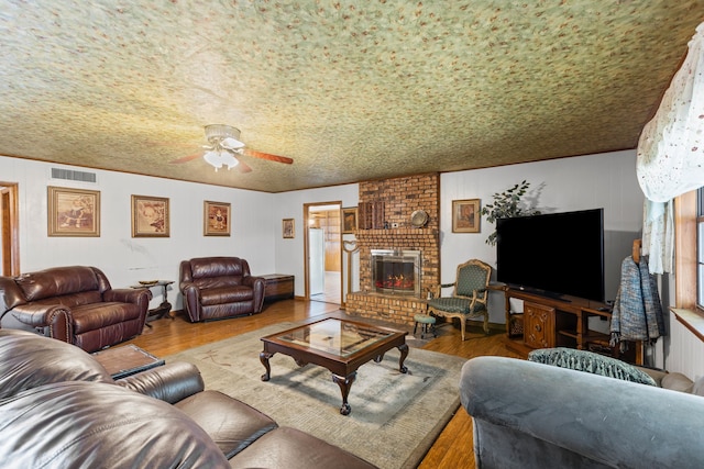100 Yorkshire Dr, Princeton, TX 75407 - living area with a ceiling fan, wood finished floors, and a brick fireplace