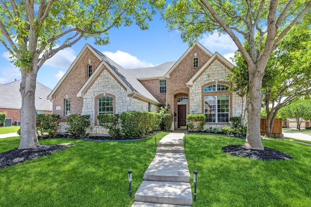 8905 Glen Garden Dr, Mckinney, TX 75072 - french provincial home with stone siding and a front yard