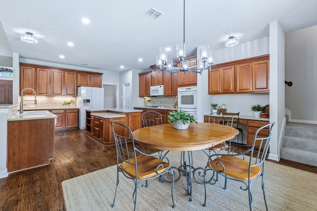 8905 Glen Garden Dr, Mckinney, TX 75072 - dining room featuring dark wood finished floors, recessed lighting, a chandelier, and baseboards