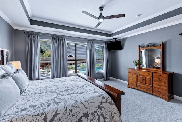 8905 Glen Garden Dr, Mckinney, TX 75072 - carpeted bedroom with a tray ceiling, ornamental molding, baseboards, and a ceiling fan