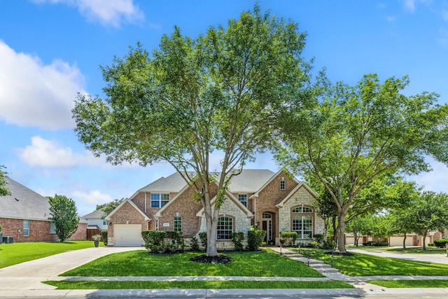 8905 Glen Garden Dr, Mckinney, TX 75072 - traditional home featuring stone siding, concrete driveway, a front yard, and a garage