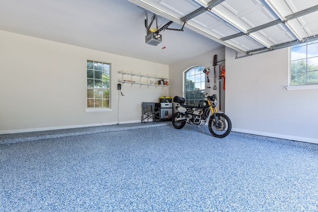 8905 Glen Garden Dr, Mckinney, TX 75072 - garage featuring a garage door opener and baseboards