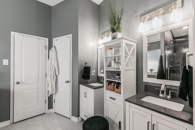 4408 Ashbury Ln, Mansfield, TX 76063 - bathroom featuring a shower stall, baseboards, vanity, and tile patterned floors