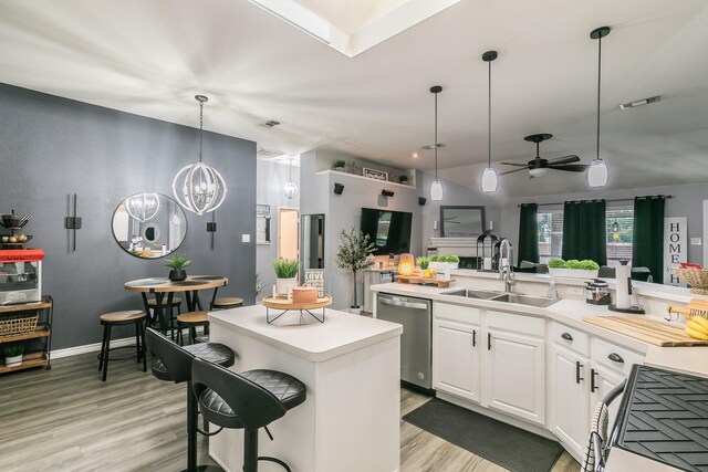 4408 Ashbury Ln, Mansfield, TX 76063 - kitchen featuring stainless steel dishwasher, a center island, stove, light wood finished floors, and a sink
