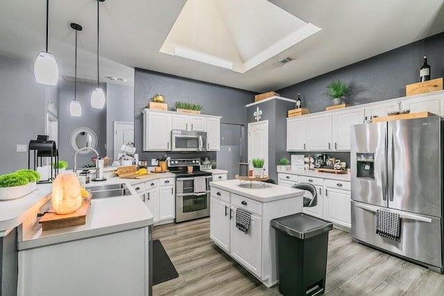 4408 Ashbury Ln, Mansfield, TX 76063 - kitchen featuring stainless steel appliances, white cabinets, light wood-style floors, and light countertops