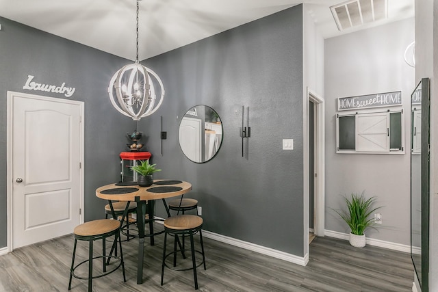 4408 Ashbury Ln, Mansfield, TX 76063 - dining room featuring baseboards, wood finished floors, and a chandelier