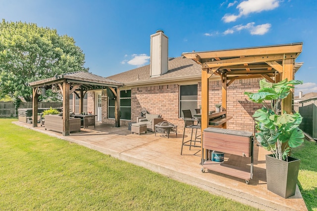 4408 Ashbury Ln, Mansfield, TX 76063 - back of house featuring a gazebo, brick siding, a patio area, and an outdoor living space