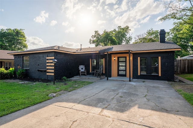 3229 Santiago Dr, Mesquite, TX 75150 - view of front of house with a chimney, brick siding, and covered porch